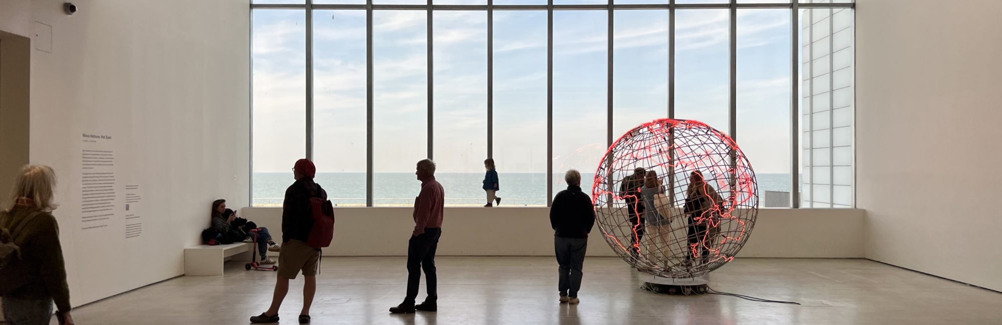 Art installation inside Turner Contemporary with sea and beach visible through large windows