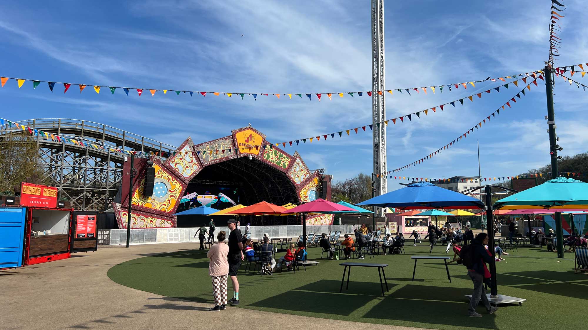 Dreamland Margate’s iconic Scenic Railway, colourful bunting, and open-air stage on a bright day.