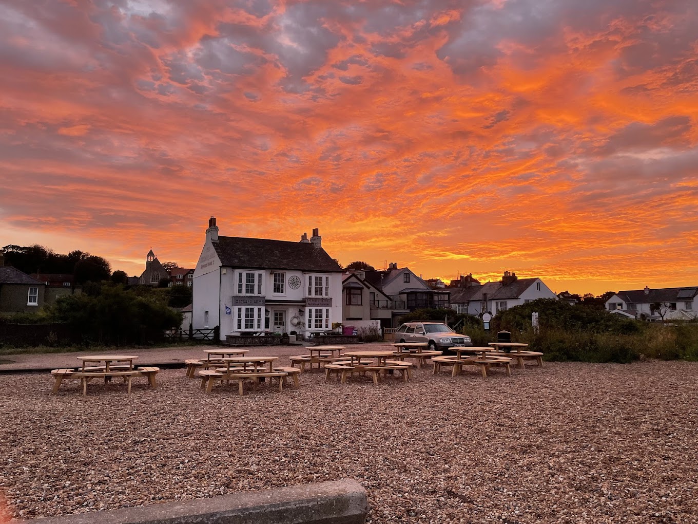 The Zetland Arms pub on the shingle beach at Kingsdown near Deal, Kent, glowing at sunset